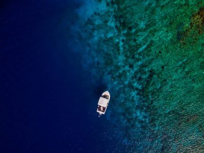 Boat at a coral reef viewed from above