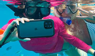 Women snorkeling with a phone
